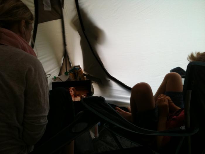 Sheltering inside the tent from the rain