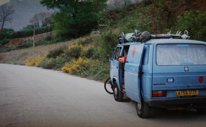 Blue T25 panel van parked on a country road with the side door open