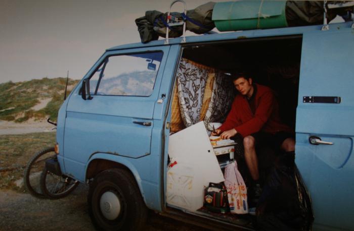 Sitting in the open side door of the blue T25 panel van