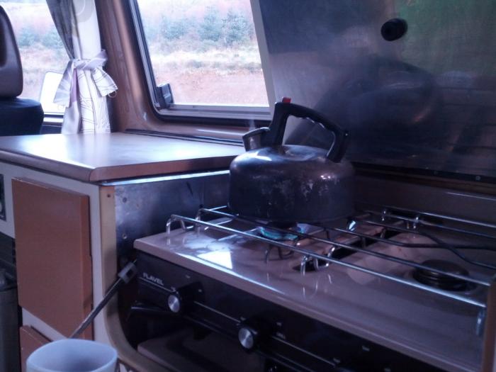 Kettle on the stove inside the camper