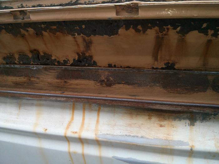 Close-up of rust along a panel seam