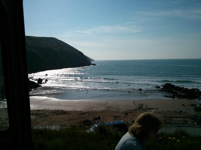 View over a beach and the sea from the campsite
