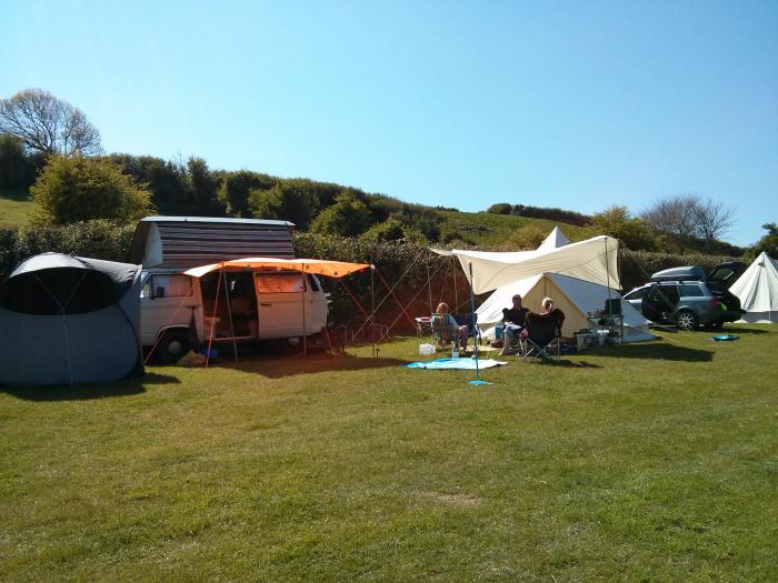 Campsite with the T25 and an orange canopy