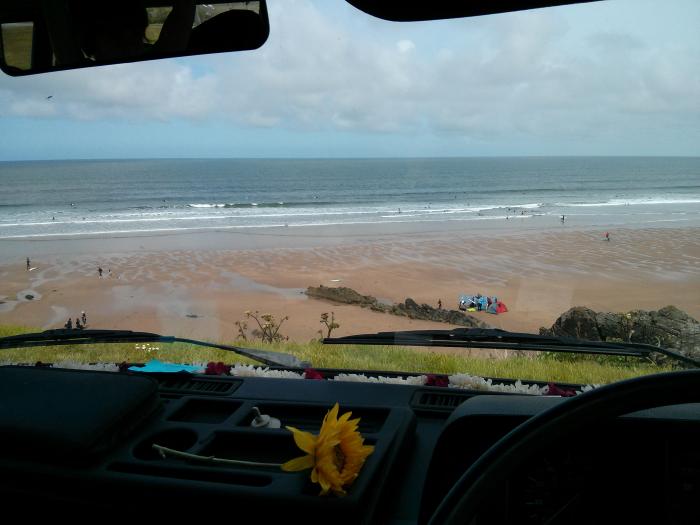 Looking out through the windscreen at the beach and sea