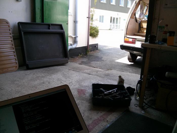 Laptop open in a garage workshop