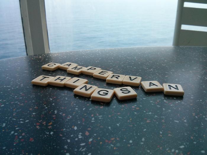 Scrabble tiles spelling Camper Van Things on a ferry table