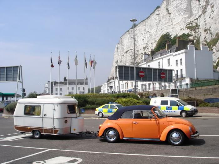 Orange VW Beetle towing an Eriba caravan