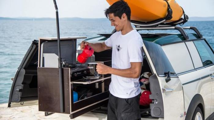 Making coffee at a slide-out kitchen in a Mini Clubman