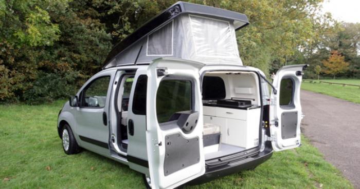 Romahome camper with its doors open and pop top raised