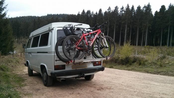 Rocky with bikes on the back in a forest car park
